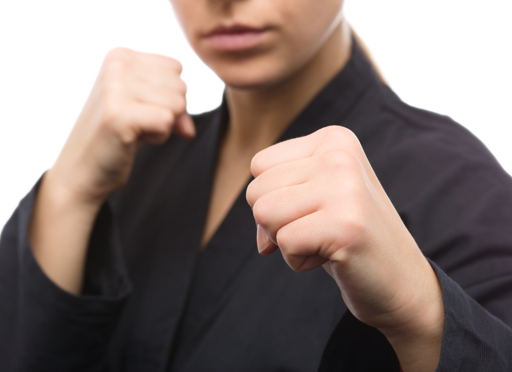 A woman performing the karate hand gesture